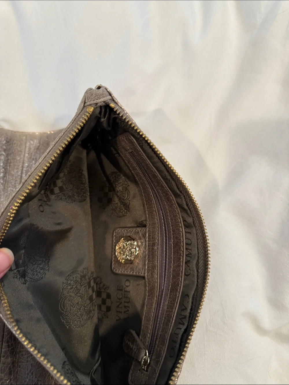Leather Zip reversible clutch in Metallic taupe and reverses to rose gold